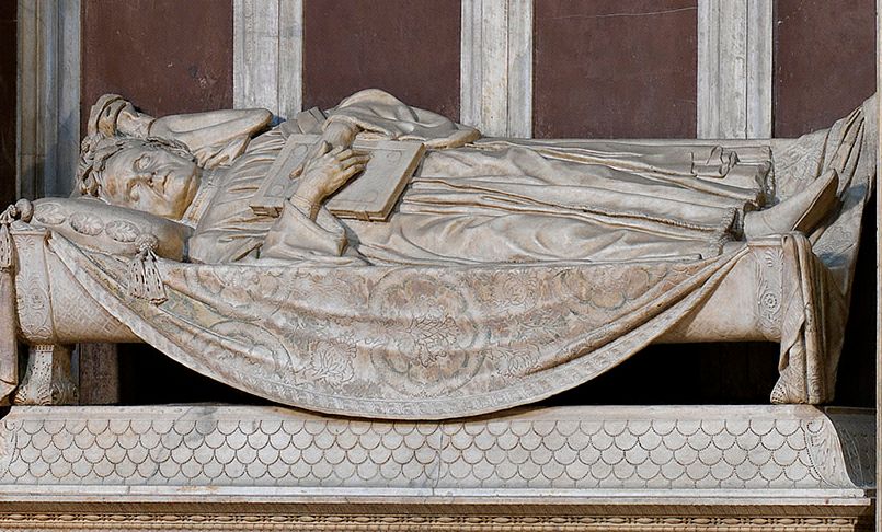 Marsuppini lying on his tomb with a book in his hands.