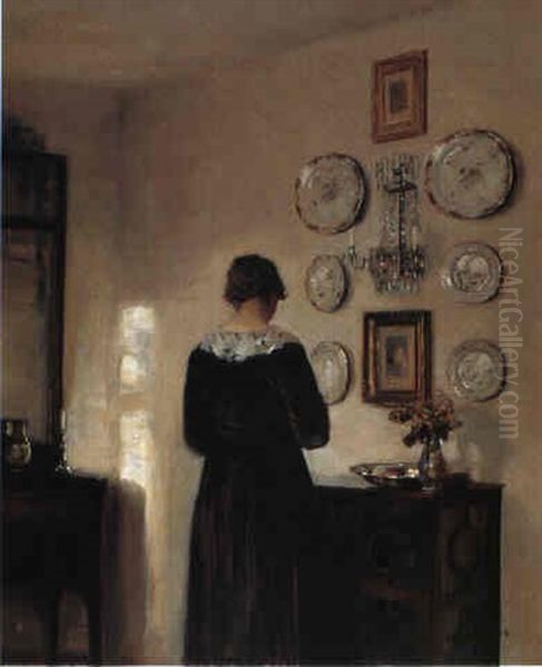 Interior Med Ung Rygvendt Pige Ved En Kommode by Carl Vilhelm Holsoe