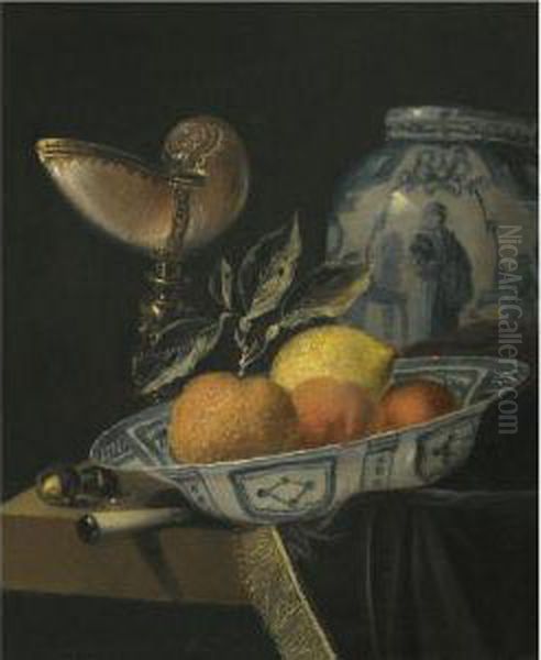 A Still Life Of An Orange, A Lemon And Two Peaches In A Wan-liporcelain Bowl On A Table With A Fringed Carpet And A Nautiluscup Oil Painting by Juriaen van Streeck