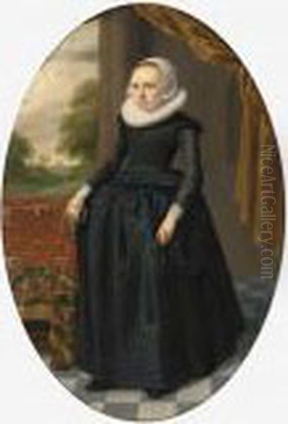 A Portrait Of A Lady, Standing 
Full-length, Wearing A Black Dress With Lace Collar And Bonnet, Holding 
Gloves, Near A Table Draped With A Persian Carpet Oil Painting by Thomas De Keyser