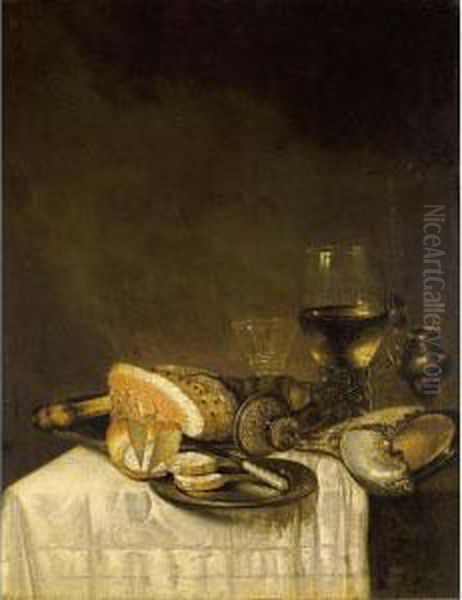 A Still Life With A Nautilus 
Cup, A Roemer, A Wineglass, A Ham, Bread And A Knife On Pewter Plates 
Together With A Silver Gilt Mustard Jar, All On A Table Draped With A 
White Tablecloth Oil Painting by Willem Claesz. Heda