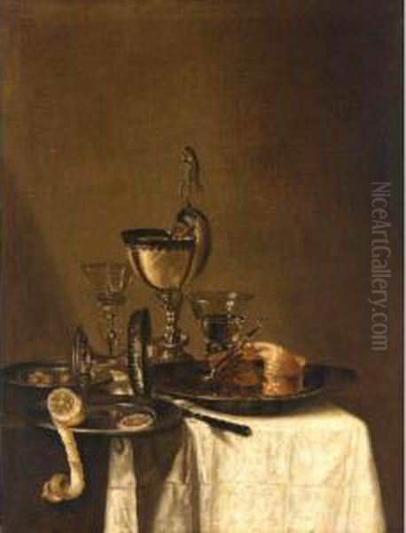 Still Life Of A Nautilus Cup, An
 Overturned Tazza, A Partially Eaten Pie In A Pewter Bowl And A Knife, 
Together With Two Wine Glasses, And Olives And A Peeled Lemon In Pewter 
Dishes, All Arranged Upon A Table Top Partly Draped With A White Cloth Oil Painting by Willem Claesz. Heda