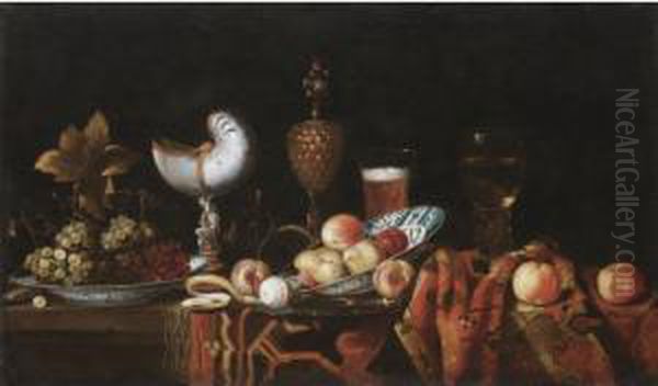 Still Life With Pears, Apples, 
Grapes In A Ceramic Bowl, A Partly Peeled Lemon, A Nautilus Cup, A 
Roemer And A Beer Glass, All Arranged On A Table Partly Draped With A 
Carpet Oil Painting by Johann Georg (also Hintz, Hainz, Heintz) Hinz