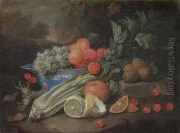 Apricots And Grapes In A Wan-li 
Kraak Blue Andwhite Bowl On A Table Ledge, With A Peeled Lemon, Celery, 
Cherriesand Walnuts, Before A Landscape Oil Painting by Joris Van Son