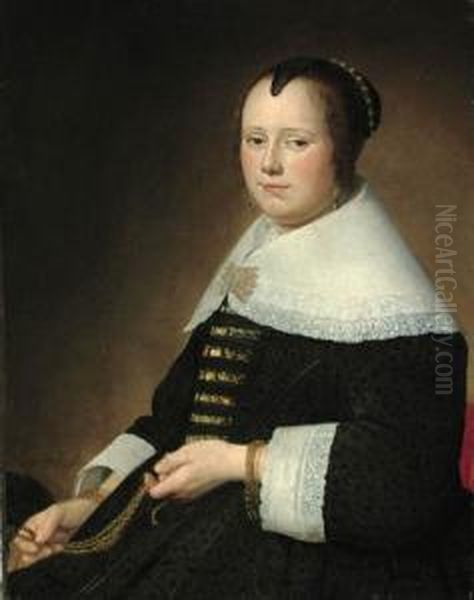 Potrait Of A Lady, 
Three-quarter-length, In A Black Dress With Gold Brocade, And A White 
Collar, Holding A Gold Chatelaine Oil Painting by Johannes Cornelisz. Verspronck