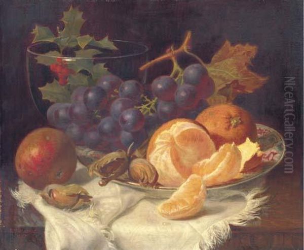 An Apple, Black Grapes, Two 
Oranges And Cob Nuts On Oriental Plate,with Holly In A Glass Vase, On A 
Wooden Table Oil Painting by Eloise Harriet Stannard