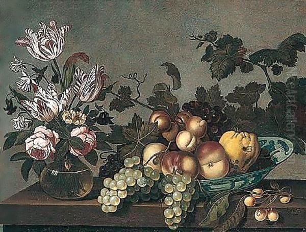 Still Life Of Peaches, Grapes And A Pear In A Blue And White Porcelain Bowl, Together With Variegated Tulips And Roses In A Glass Vase, Arranged Upon A Stone Ledge Oil Painting by Joris Van Son