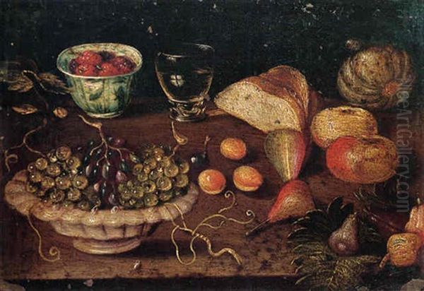 Still Life Of A Bowl Of Grapes And Raspberries In A Blue And White Cup, Together With Other Fruits, Bread And A Glass Of Wine by Osias Beert the Elder