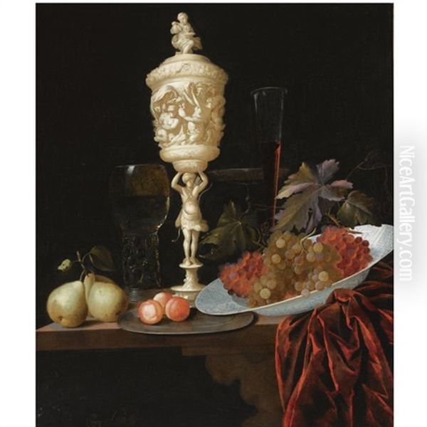 A Still Life With An Ivory Carved Cup And Cover, A Roemer, Pears, Prunes On A Pewter Plate, Grapes In A Porcelain Wan-li Bowl, A Flute-glass And A Tazza, All On A Wooden Ledge Draped With A Red Velvet Oil Painting by Georg Hainz