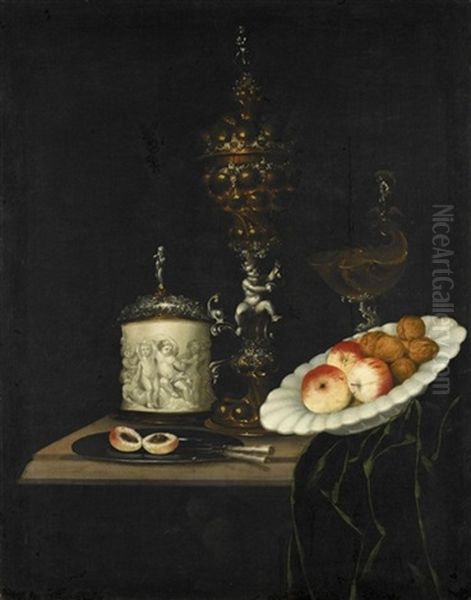 A Still Life Of Apples And Walnuts In A Ceramic Dish, A Silver And Gilt Cup And Cover, A Silver And Gilt Nautilus Shell Tazza, And Other Utensils On A Table Partly Draped With A Green Cloth Oil Painting by Georg Hainz