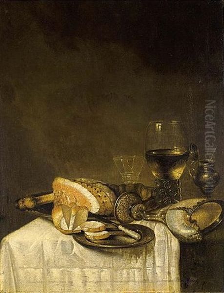 A Still Life With A Nautilus Cup, A Roemer, A Wineglass, A Ham, Bread And A Knife On Pewter Plates Together With A Silver Gilt Mustard Jar, All On A Table Draped With A White Tablecloth Oil Painting by Willem Claesz Heda