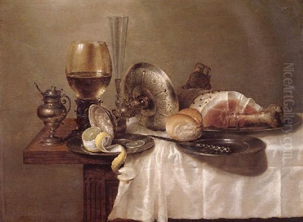 A Still Life Of A Roemer, An Overturned Silver Tazza, A Flute, Pewter Plates, A Partly Peeled Lemon, A Bread Roll And A Ham Oil Painting by Willem Claesz Heda