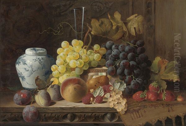 A Ginger Jar With Plums, A Peach, Pear, Raspberries, Whitecurrants, Black And White Grapes, Strawberries, A Glass Flute, Amother-of-pearl Box And A Rug On A Carved Wooden Table Oil Painting by Charles E. Baskett