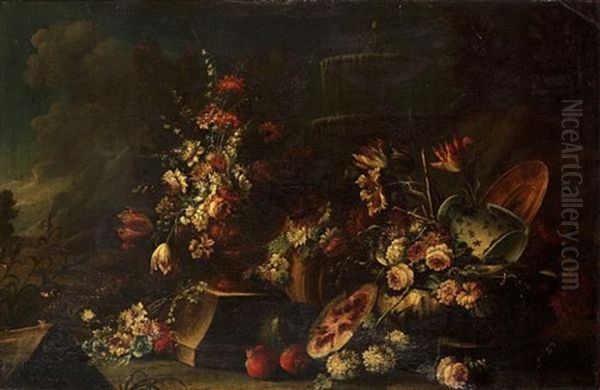 Carnations, Tulips, Peonies In An Urn With Other Flowers, A Melon, Pomegranates And A Blue And White Pottery Vase Before A Fountain In A Landscape Oil Painting by Giuseppe Lavagna