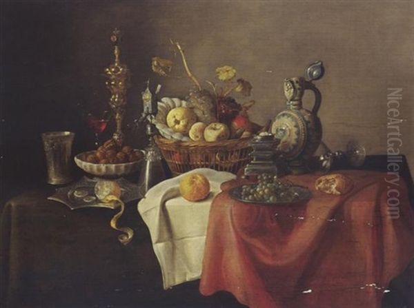 A Sumptuous Still Life With A Silver-giltbeaker, A Lemon, Walnuts, A Cup, A Glass, Fruit In A Basket, And Bread On A Draped Table Oil Painting by Cornelis Mahu