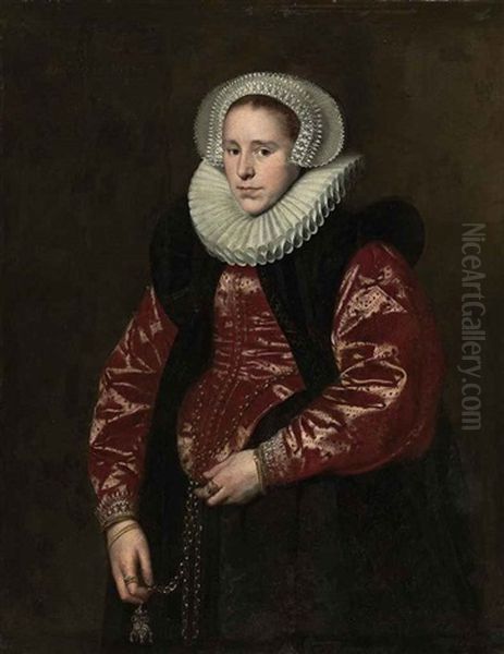 Portrait Of A Lady In A Lace Bonnet, Ruff, Red Gown With A Black Velvet Mantle, Holding A Jewelled Gold Pomander Oil Painting by Paulus Moreelse