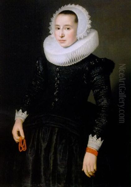 Portrait Of A Young Lady Wearing A Black Dress With Lace Cuffs And Molenkraag, Lace Bonnet And Red Corals In Her Right Hand Oil Painting by Nicolaes Eliasz Pickenoy