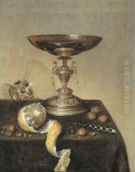 A Silver Tazza, An Upturned Roemer, A Partly-peeled Lemon, A Knifeand Hazelnuts On A Draped Table Oil Painting by Maerten Boelema De Stomme