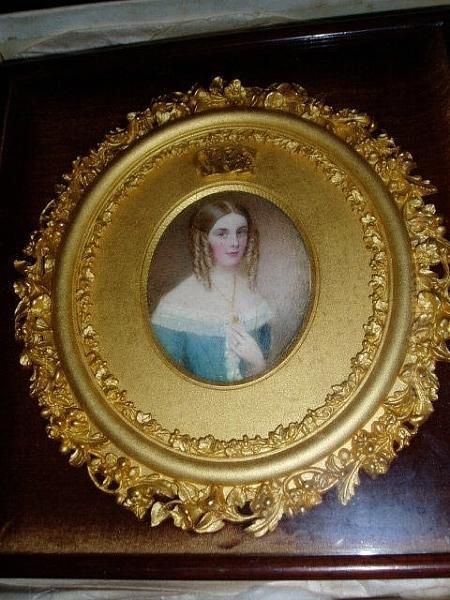 A Portrait Of A Young Lady, Her Fair Hair In Ringlets And Wearing A Blue Gown With Lace Trimming And Gold Jewellery Oil Painting by William Egley