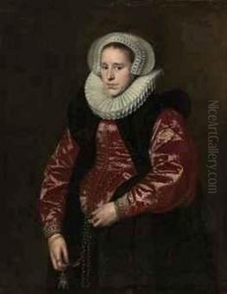 Portrait Of A Lady, Half-length, In A Lace Bonnet, Ruff, Red Gown With A Black Velvet Mantle, Holding A Jewelled Gold Pomander Oil Painting by Paulus Moreelse