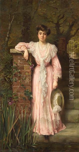 A Portrait Of A Lady In A Garden Wearing A Pink Dress Holding An Iris Oil Painting - Thomas Benjamin Kennington