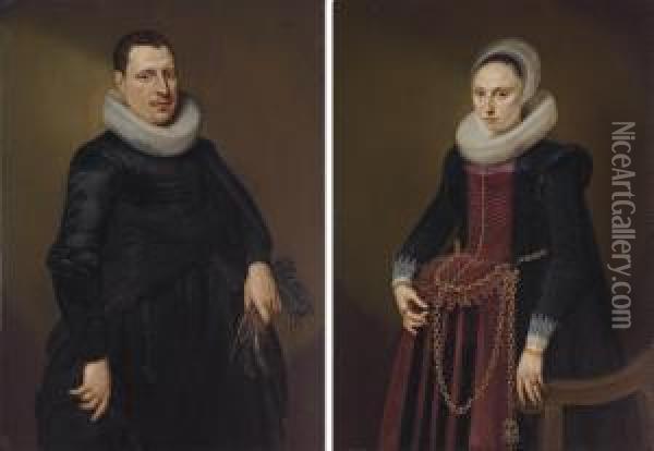 Portrait Of A Gentleman, 
Three-quarter Length, In A Black Coat With White Collar, Holding A Pair 
Of Gloves; And Portrait Of A Lady, Three-quarter Length, In A Black And 
Red Dress With Gold Chains, By A Chair Oil Painting - Cornelis van der Voort